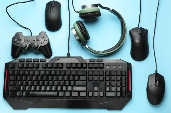 Modern gaming accessories on color background