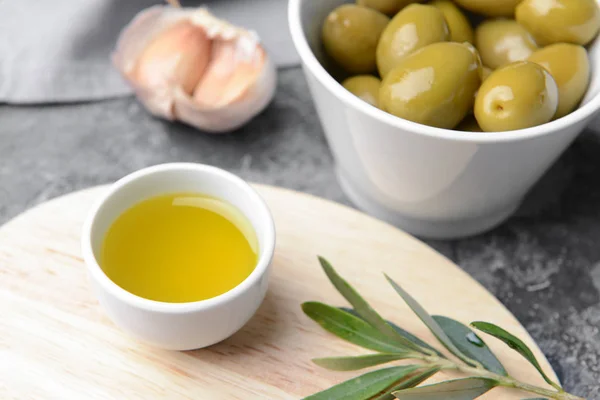 Bowl with tasty olive oil on table — Stock Photo, Image