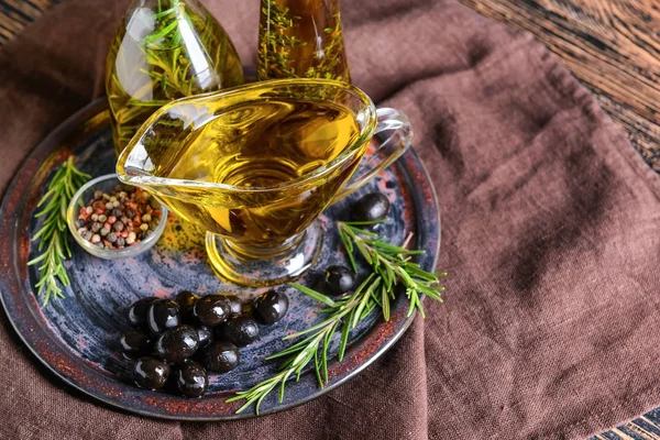 Plate with tasty olive oil and spices on table — Stock Photo, Image