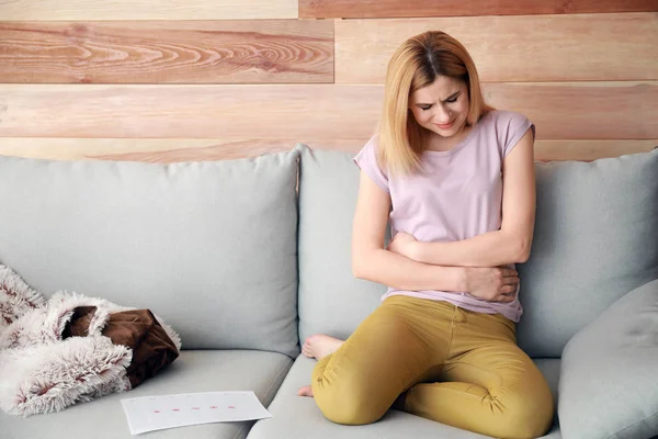Beautiful woman suffering from abdominal pain at home — Stock Photo, Image