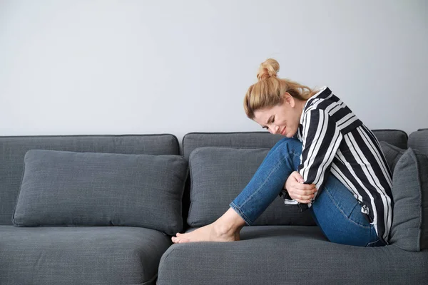 Beautiful woman suffering from abdominal pain at home — Stock Photo, Image