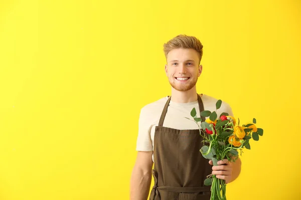 Handsome florist on color background — Stock Photo, Image