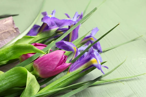 Beautiful flowers on wooden table — Stock Photo, Image