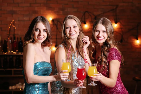 Beautiful young women with cocktails in club — Stock Photo, Image