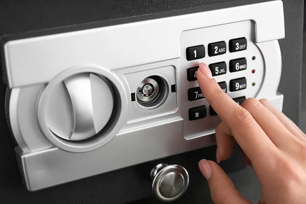 Woman opening modern safe, closeup — Stock Photo, Image