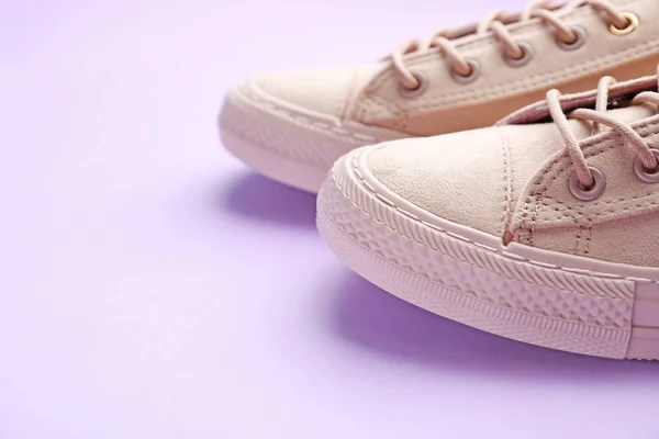 Pair of stylish casual shoes on color background, closeup