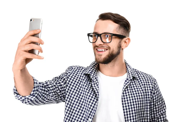 Portrait of handsome man taking selfie on white background — Stock Photo, Image