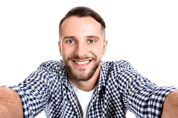 Portrait of handsome man taking selfie on white background — Stock Photo, Image