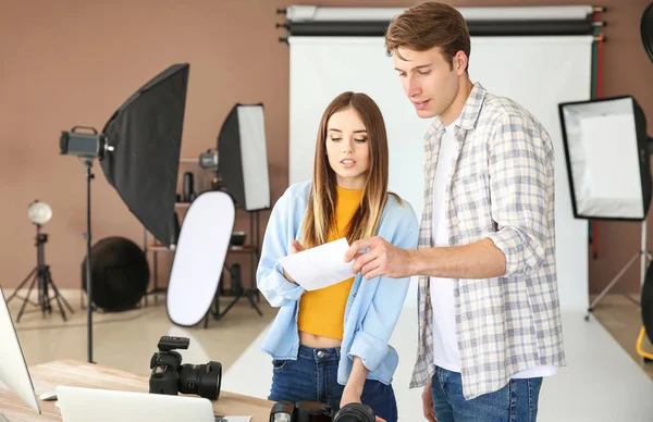 Professional photographers discussing pictures in modern studio — Stock Photo, Image