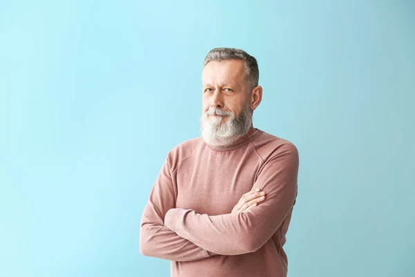 Portrait of handsome senior man on color background — Stock Photo, Image