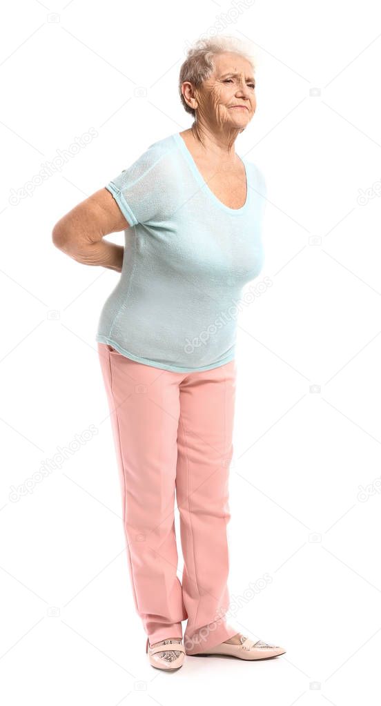 Senior woman suffering from back pain on white background