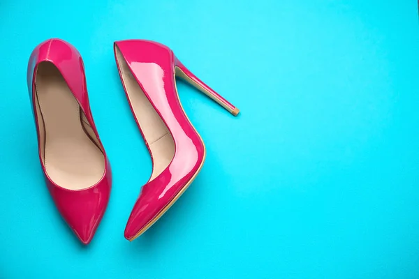 Stylish high heeled shoes on color background — Stock Photo, Image