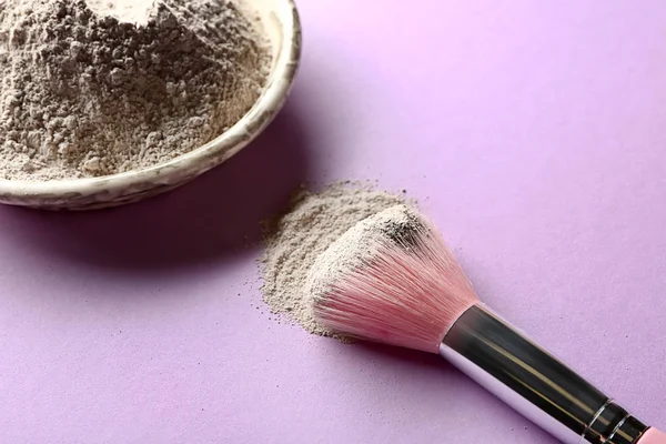 Cosmetic clay with brush on color background — Stock Photo, Image