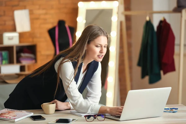 Beautiful female business owner working in atelier — Stock Photo, Image