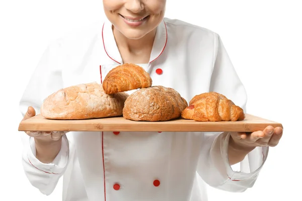 Female chef with bakery products on white background — Stock Photo, Image