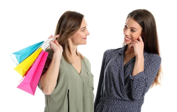 Portrait of happy mother and daughter with shopping bags on white background — Stock Photo, Image