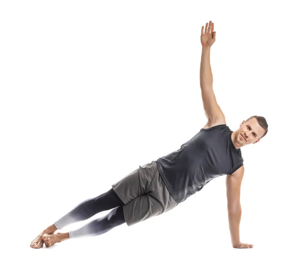 Hombre deportivo practicando yoga sobre fondo blanco —  Fotos de Stock