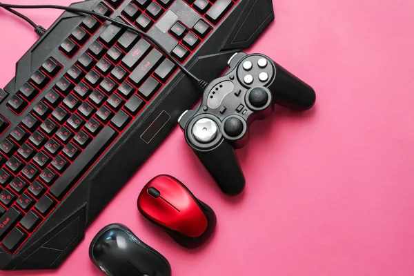 Modern gaming accessories on color background