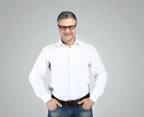 Portrait of stylish mature man on grey background — Stock Photo, Image