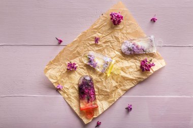 Ahşap masa üzerinde taze leylak çiçekleri ile Çiçek popsicles