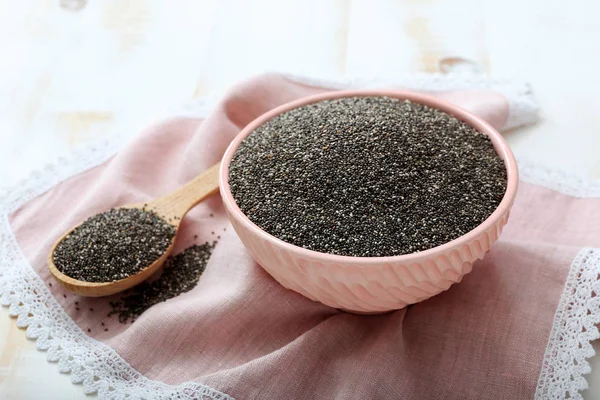 Spoon and bowl with chia seeds on table — Stock Photo, Image