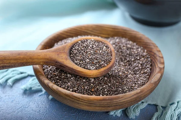 Spoon and bowl with chia seeds on table — Stock Photo, Image