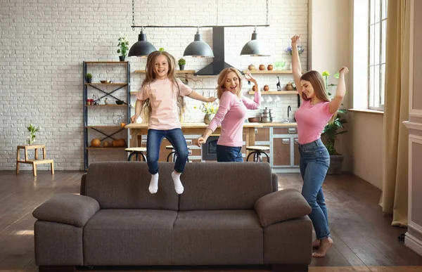 Happy girl with her mother and grandmother having fun at home — Stock Photo, Image