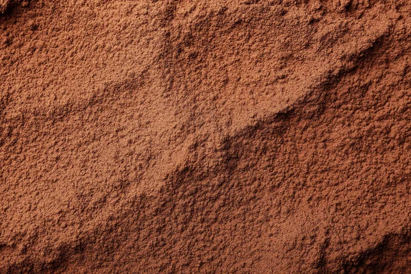 Konsistens av kakaopulver som bakgrund — Stockfoto