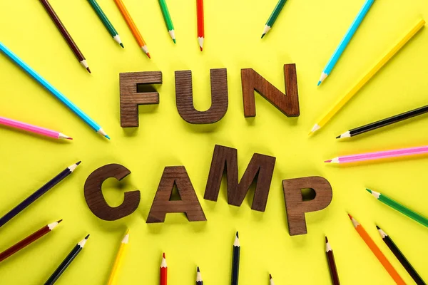 Pencils and text FUN CAMP on color background — Stock Photo, Image