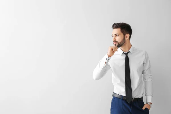 Fashionable young man on grey background — Stock Photo, Image