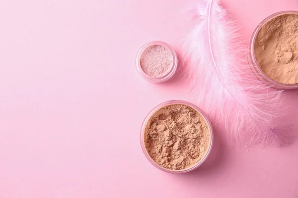 Different facial powder on color background