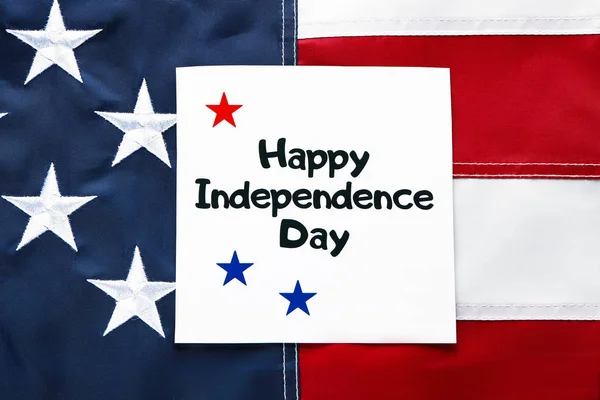 Card with text HAPPY INDEPENDENCE DAY on the USA flag — Stock Photo, Image