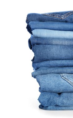 Beyaz arka planda kot pantolon yığını