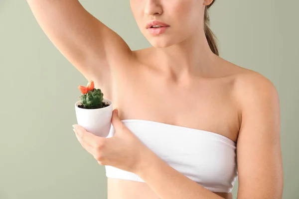 Beautiful young woman with cactus on color background. Depilation concept — Stock Photo, Image