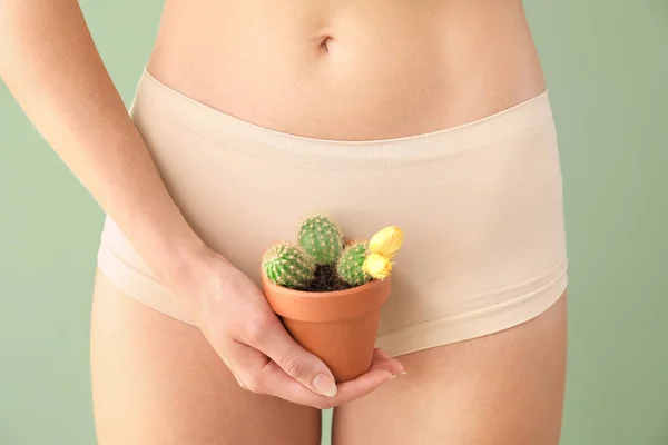 stock image Beautiful young woman with cactus on color background. Depilation concept