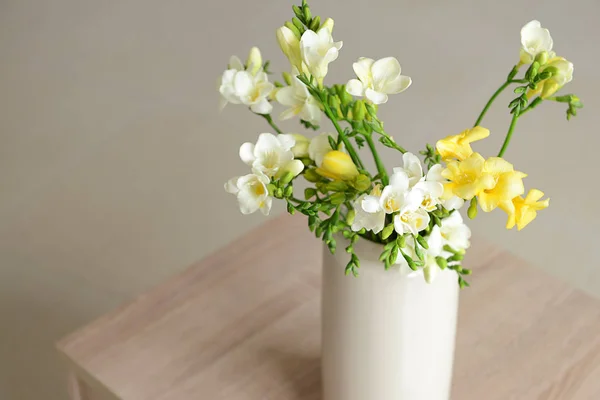 Vase with beautiful freesia flowers on table — Stock Photo, Image
