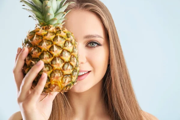 Beautiful young woman with pineapple on white background — Stock Photo, Image