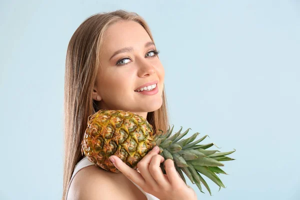 Beautiful young woman with pineapple on white background — Stock Photo, Image