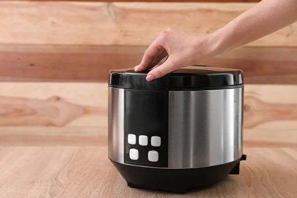 Woman using modern multi cooker on table — Stock Photo, Image