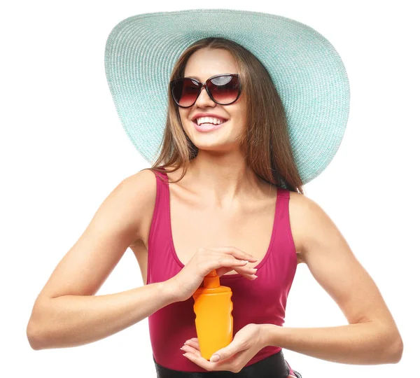 Schöne junge Frau mit einer Flasche Sonnenschutzcreme auf weißem Hintergrund — Stockfoto