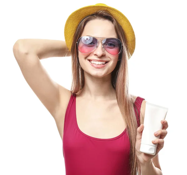 Beautiful young woman with tube of sun protection cream on white background — Stock Photo, Image