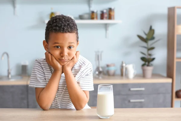 Cute African-American boy with glass of milk at table — Stock Photo, Image