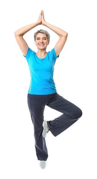 Mature woman practicing yoga on white background Stock Photo