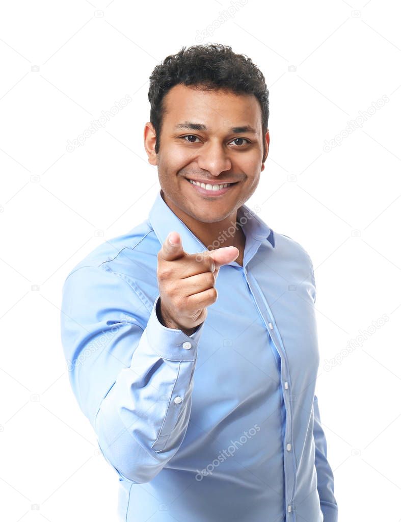 Portrait of handsome businessman pointing at viewer on white background