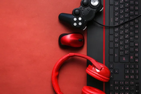 Modern gaming accessories on color background