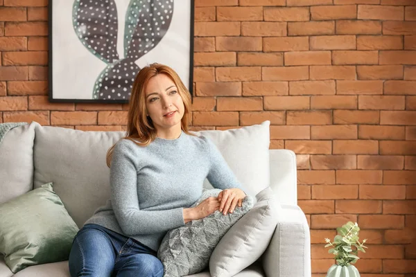 Portrait of mature woman resting on sofa at home — Stock Photo, Image