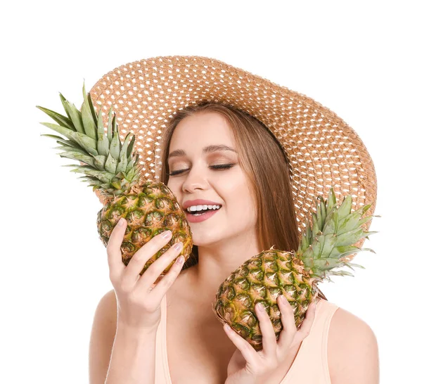 Beautiful young woman in swimming suit and with pineapples on white background — Stock Photo, Image