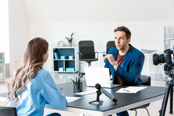 Human resources manager interviewing woman in office