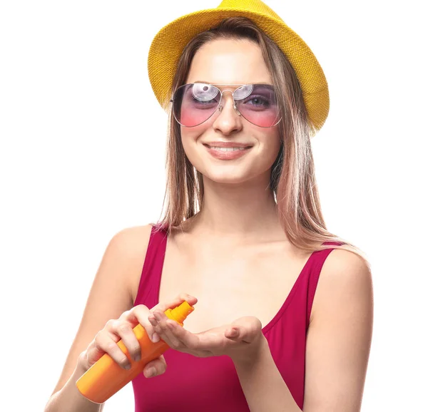Beautiful young woman with bottle of sun protection cream on white background — Stock Photo, Image
