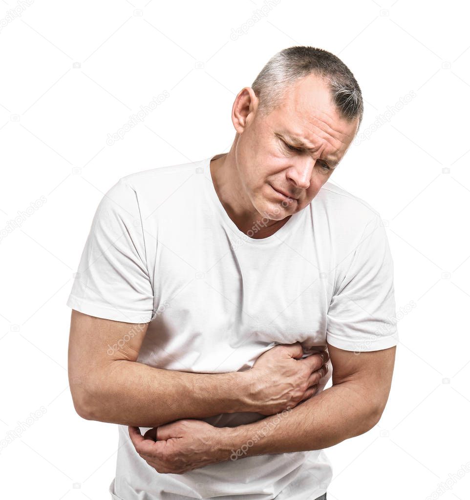 Handsome middle-aged man suffering from stomach pain on white background